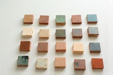 Various glazed ceramic samples showing different colors and textures